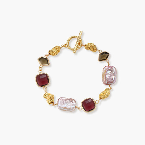 Bracelet featuring deep red stones, pink freshwater pearls, and gold nuggets with a toggle clasp for elegance and sophistication.