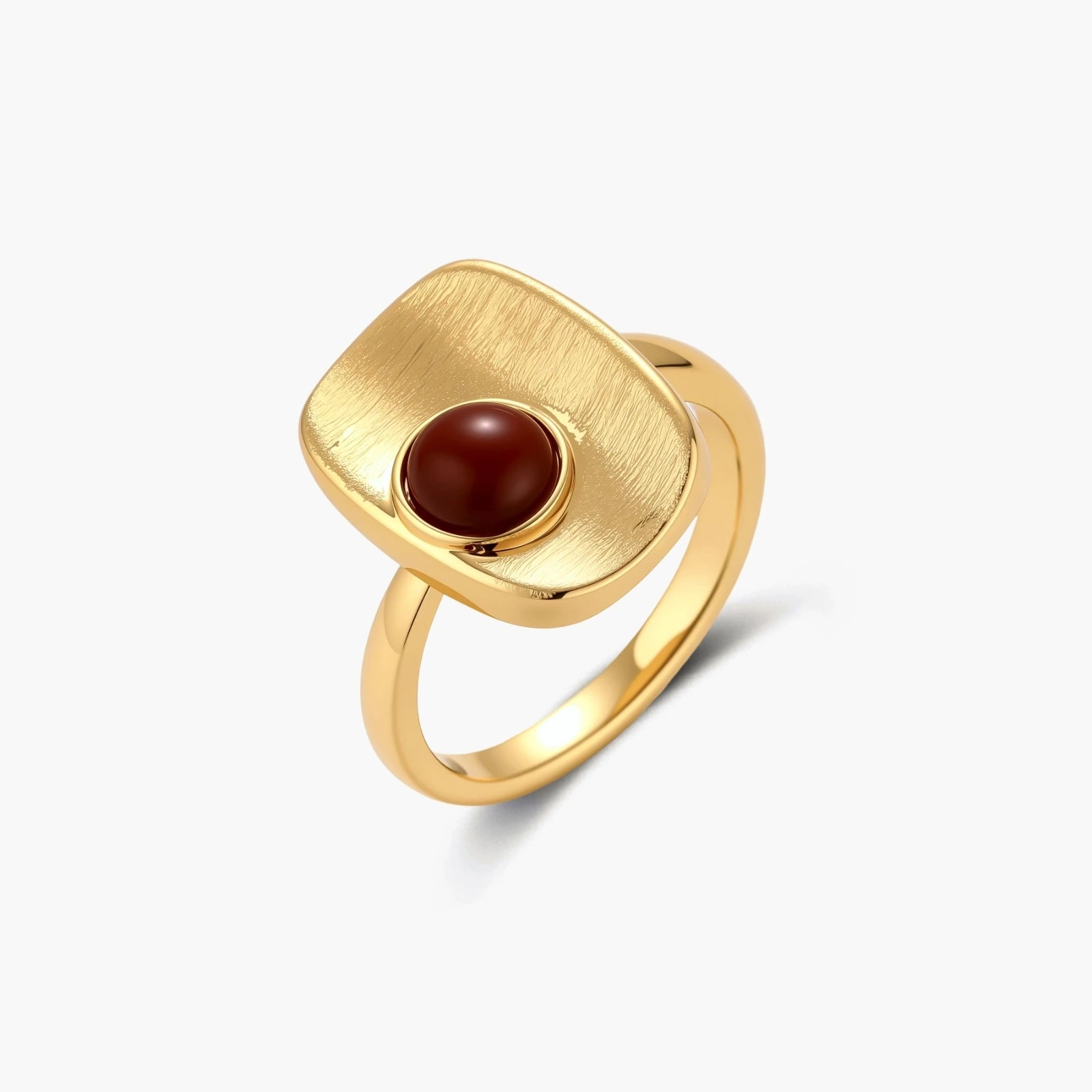 Close-up of brushed 18K gold-plated ring featuring red nanhong stone in geometric square setting with adjustable band