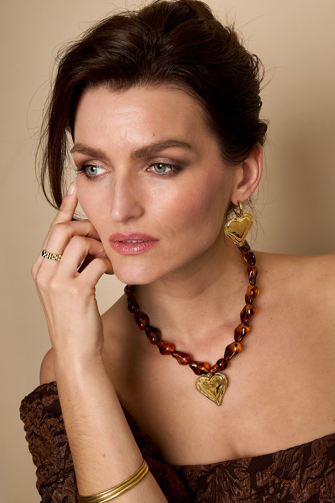 Beaded necklace with naturally shaped beads and a hanging heart