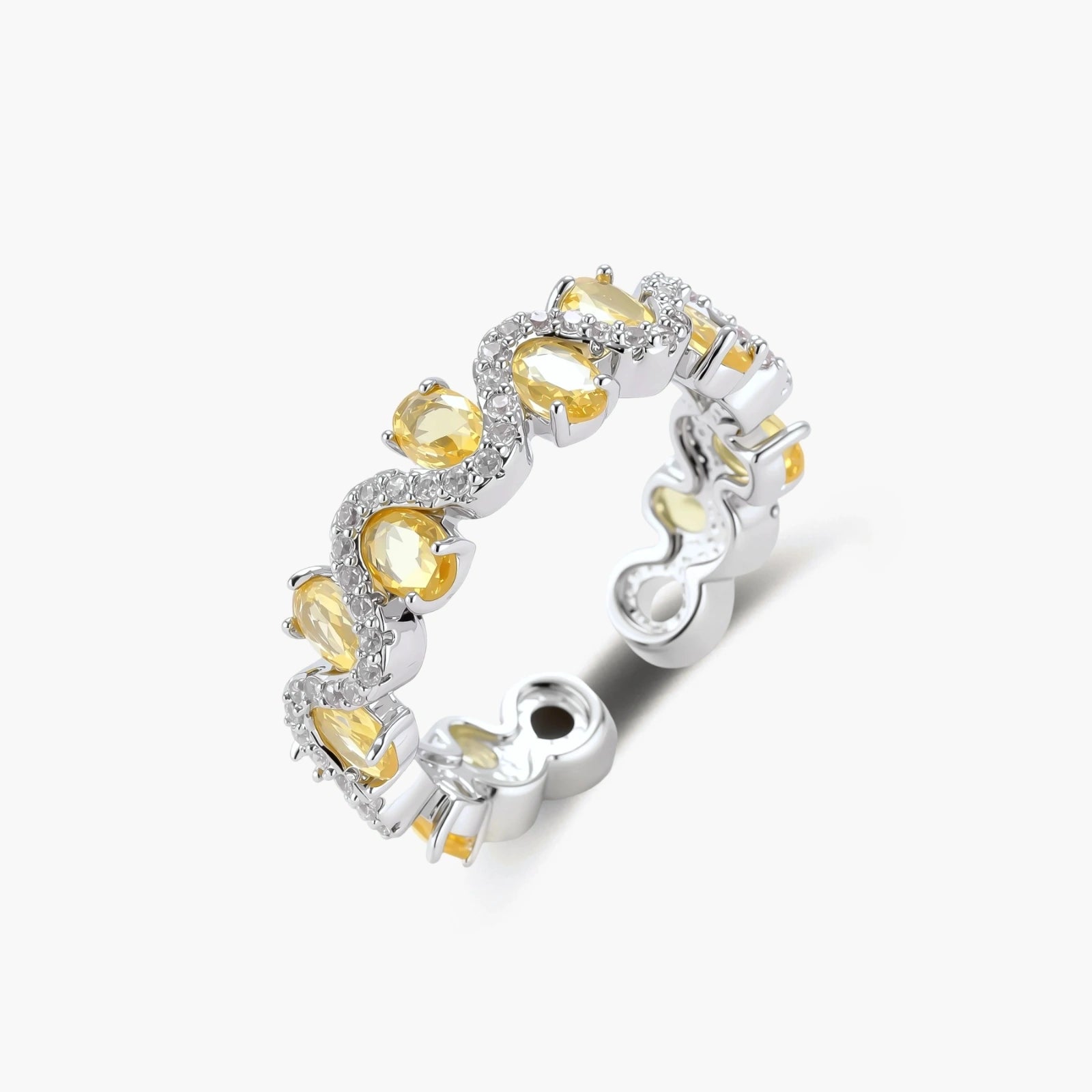 Close-up of an adjustable ring with golden zirconia stones in oval settings and clear accent stones on white gold-plated band.