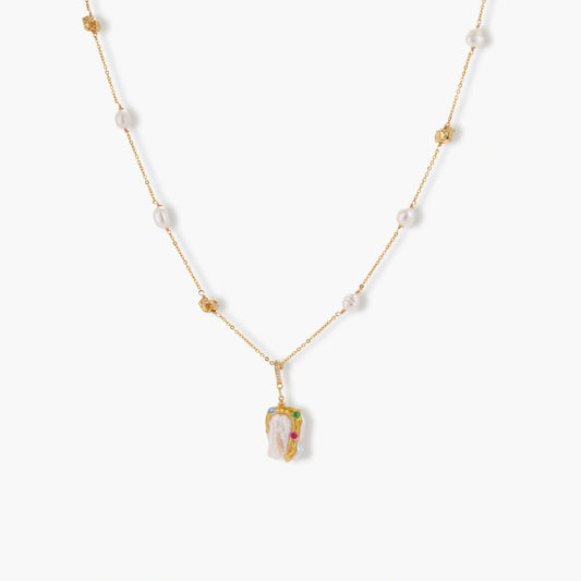 Delicate 18k gold-plated chain with baroque pearls and colorful enamel pendant featuring blue, pink accents on cream background.