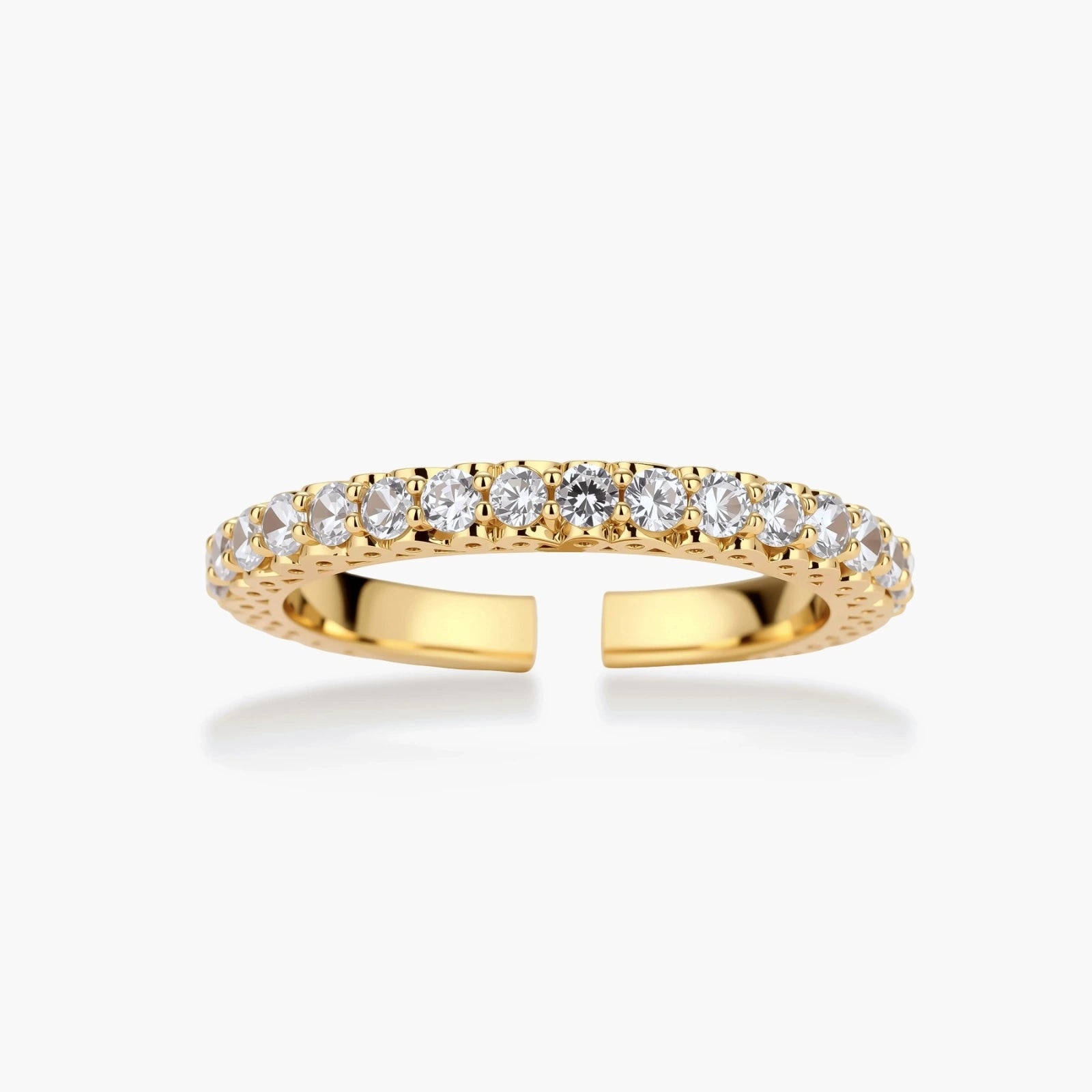 Close-up of adjustable gold-plated ring with continuous row of round zirconia stones on neutral background.