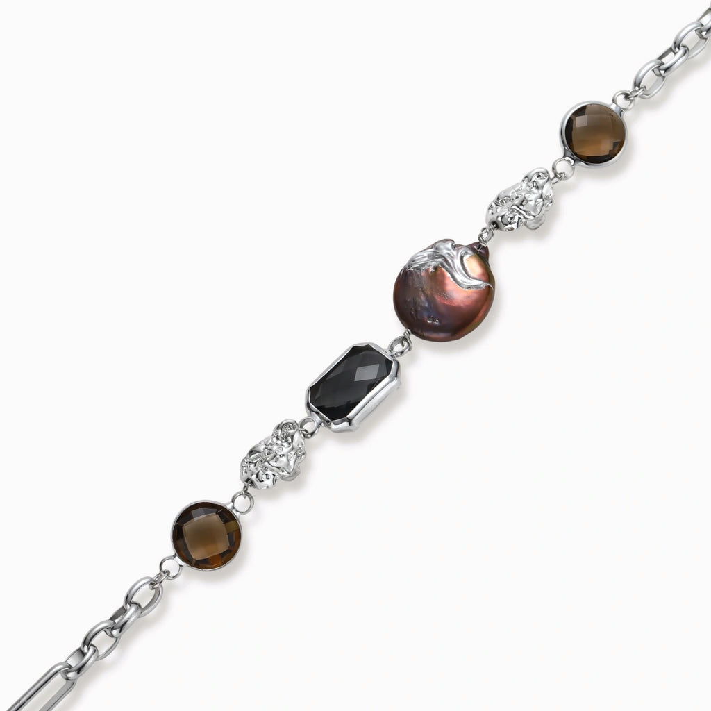 Chain bracelet with amber stones, baroque pearl, and dark rectangular stone on white gold-plated copper base.