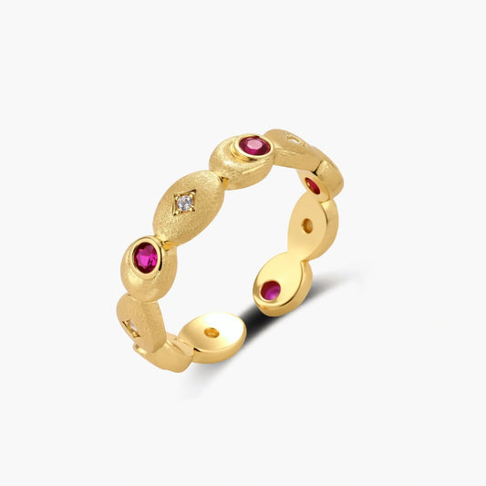 Textured gold ovals entwined in a luxurious ring, adorned with deep pink-red zirconias and delicate white sparkles.