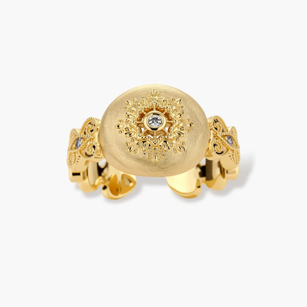Ornate gold-plated ring with detailed engravings and central zirconia stone on adjustable band