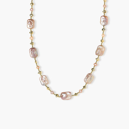 Soft pink baroque and round freshwater pearls elegantly arranged on a delicate gold chain, interspersed with textured gold nuggets.