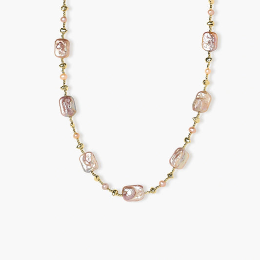 Soft pink baroque and round freshwater pearls elegantly arranged on a delicate gold chain, interspersed with textured gold nuggets.