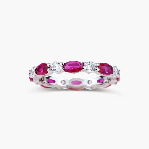 Platinum-plated eternity ring with alternating oval ruby and round clear stones in continuous band setting